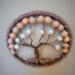 Brown polyester yarn frames 3in metal hoop. brown wire is twisted to create a tree of life. wood and faux pearl beads